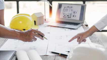 engineer meeting for architectural project. working with partner and blueprint on workplace vintage tone.