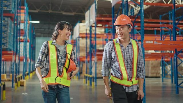 Colleague workers in warehouse factory have a greeting by high five with hands raised up at factory warehouse, Worker team working in the warehouse