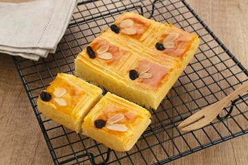 Foto op Aluminium Lekker holland or dutch butter cake (boterkoek), made of butter, flour, eggs and sugar with a sprinkling of sliced ​​almonds and raisins  © Tyas Indayanti