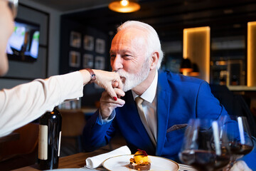 Senior elegant man kissing hand