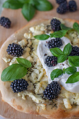 pizza with berries, mozzarella cheese and basil