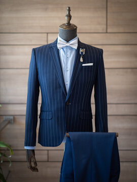 Close up of dark blue stripe jacket suit with light blue shirt , handkerchief , bow