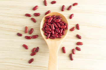 red kidney beans and spoon on wooden background, top view, flat lay, top-down, selective focus.copy space.