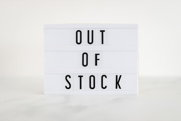 Out of stock text on lightbox on minimalistic white marble background, supply chain shortages and...