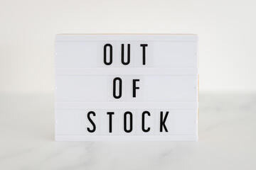 Out of stock text on lightbox on minimalistic white marble background, supply chain shortages and...