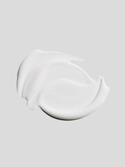 skincare cream face serum lotion white texture of different shapes and sizes on white grey background top view close up