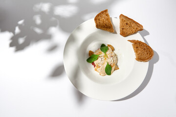 Beef tartar with mushroom espuma and foie gras on fine dining. Aesthetic composition with foie gras appetizer. Fine dining on summer. Delicatessen food on white table. - obrazy, fototapety, plakaty