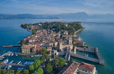 Aerial view of Sirmione, an ancient village on southern Garda Lake. Sirmione top view. Popular travel destination on Lake Garda in Italy. Scaligero Castle drone view.