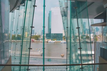 Blue window in a building looking out onto a view of the city and river