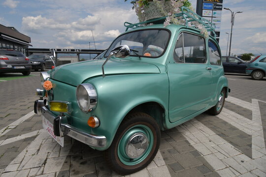 The legendary car supermini Zastava 750 (Fiat 600) which was produced from 1955 to 1985 parked in the front of the flower shop, decorated with flowers.