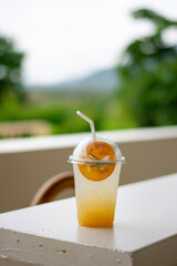 Iced lemonade soda with Yuzu orange in cafe