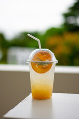 Iced lemonade soda with Yuzu orange in cafe