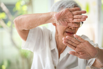 Asian old elderly woman raising hands in defence,resisting attack,victims of family domestic...