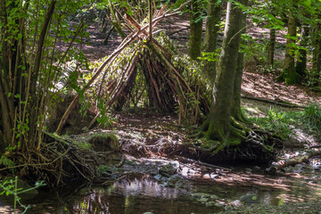 A makeshift hut with tree branches in the Acquerino Cantagallo nature reserve, Italy
