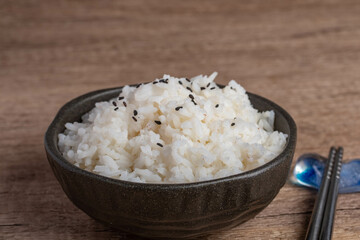 Cooked rice in a cup of black Thai jasmine rice