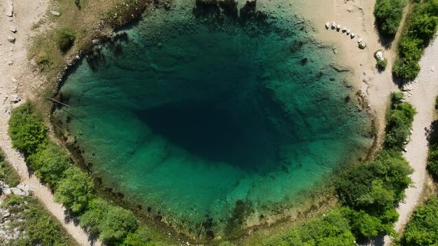 Karst Spring Flowing Into Cetina River On A Sunny Day In Croatia. - aerial ascend