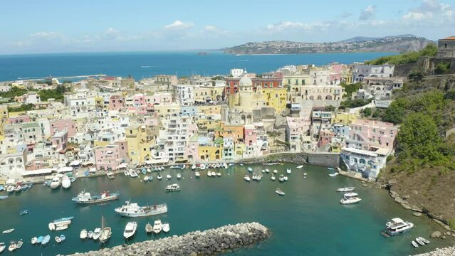 Cinematic Aerial View of Procida Italy. Neapolitan Island Town in Gulf of Naples. Fisherman harbor. Forward Drone Shot