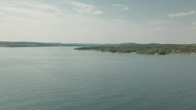Hells Gate, Possum Kingdom lake. Low passover of one of the cliffs ricky edge. revealing lake and horizon. boats on lake. low altitude.