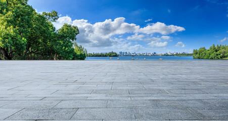 Empty square floor and beautiful lake with city skyline scenery in Hangzhou, China.