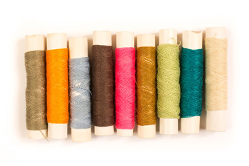 Colorful cotton yarns on rolls for sewing. Thread spools used in fabric and textile industry