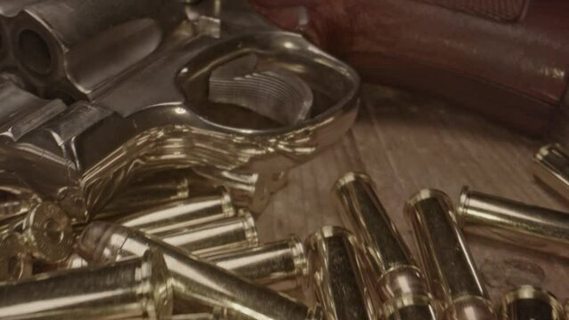 Macro dolly of bullet cartridges towards trigger of old western revolver