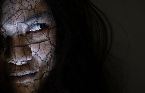 Scary ghost woman. Close up face of Asian woman ghost or zombie horror creepy scary have hair covering the face her eye at abandoned dark tone, female make up zombie broken face, Happy Halloween day