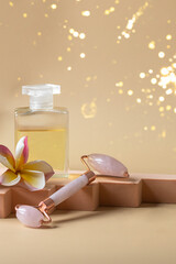 SPA composition , gua sha massage roller, essential oil ,and frangipani flower on the podium on beige background with golden sparkles. Beauty and wellness centre Holiday offer concept. .