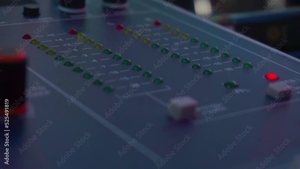 Poster Lamp indicator on the sound amplifier. LED indicator of sound level signal on the mixing console. Volume level changes of indicator bulbs. Close-up shot of strip in green, red and yellow 