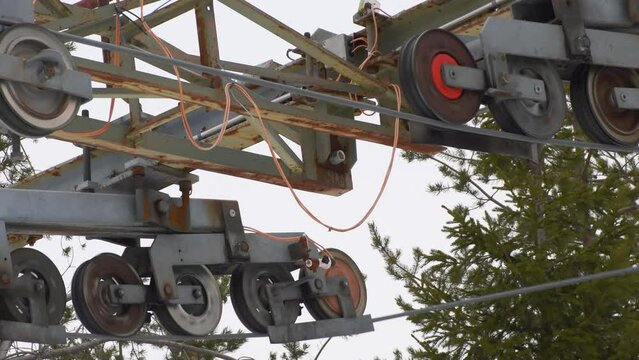 Ski lift reversal pulleys taking hit from ski lift bars teady shot.