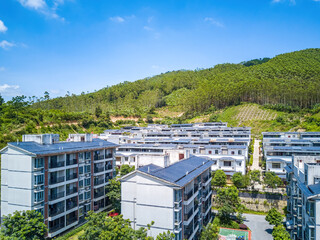 A group of villas surrounded by green hills on the outskirts of Guangxi