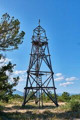 Old observation wooden fire tower on coast of Barguzinsky Bay of Lake Baikal, Russia.