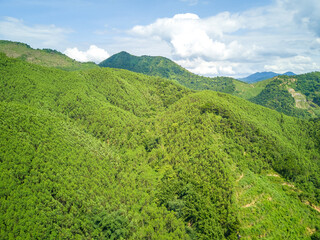 Aerial photography of green mountains, blue sky and white clouds on the outskirts of Guangxi