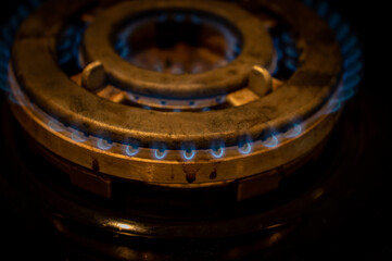 Detail of burning gas on the stove, rising gas prices an an impact of military conflict, detail of a black gas stove, price growth, economy impact of war. Cooker
