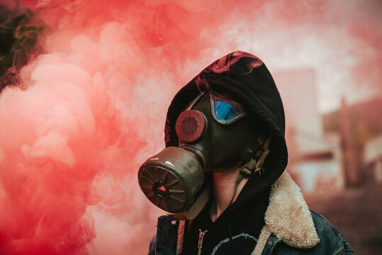 Person holding smoke bomb on street
