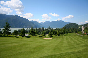 Fototapeta na wymiar Golf course fairway with beautiful moutain scenery overlooking the Howe Sound in Squamish British Columbia Canada.