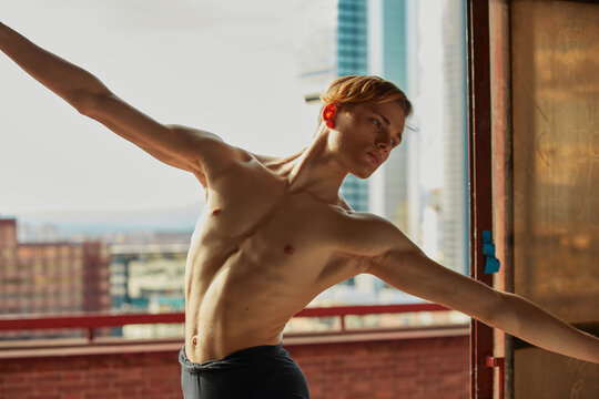Young ballet dancer posing in twine in room