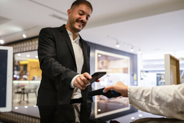 Man using contactless payment terminal