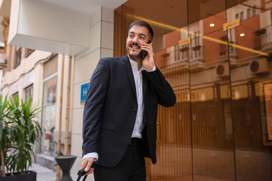 Businessman talking on smartphone on street