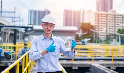 Worker under checking the waste water treatment pond industry large to control water support...