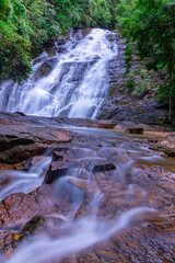 waterfalls in Phangna province in Thailand. Silky smooth running water nice brown rocks and green shrubs