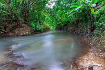 waterfalls in Phangna province in Thailand. Silky smooth running water nice brown rocks and green shrubs