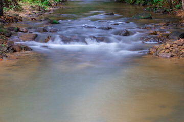waterfalls in Phangna province in Thailand. Silky smooth running water nice brown rocks and green shrubs