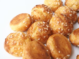 Chouquettes coated with sugar on white 