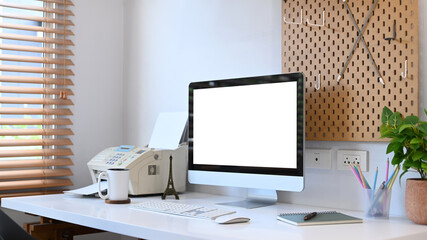 Home office desk with computer, printer, coffee cup, houseplant and stationery. Empty display for your advertise text