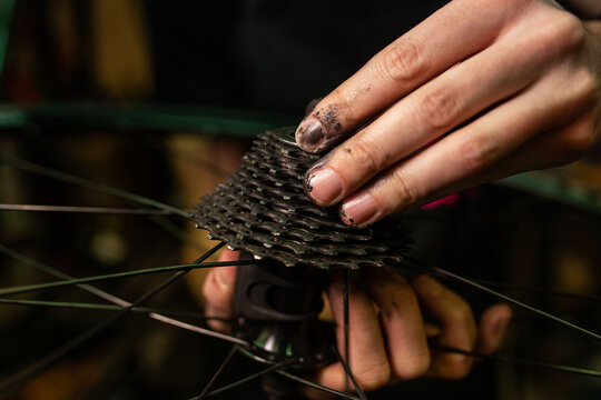 Crop mechanic repairing bike wheel