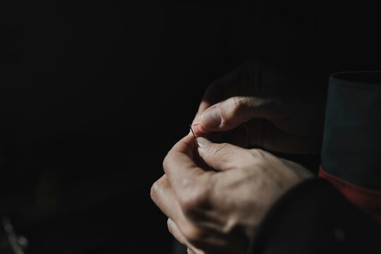 Man sewing textile in atelier