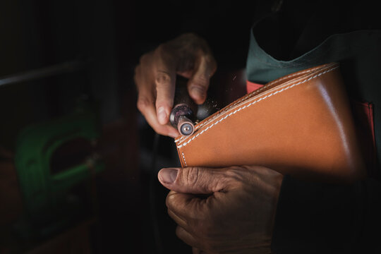 Man polishing leather in atelier