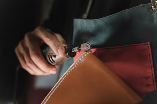 Man polishing leather in atelier