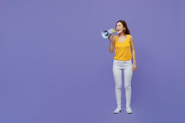 Full body young woman 20s wear yellow tank shirt hold scream in megaphone announces discounts sale Hurry up isolated on plain pastel light purple background studio portrait. People lifestyle concept.