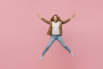 Fototapeta na wymiar Full body young fun overjoyed successful employee business woman 30s she wear casual brown classic jacket jump high with outstretched hands legs isolated on plain pastel light pink background studio.
